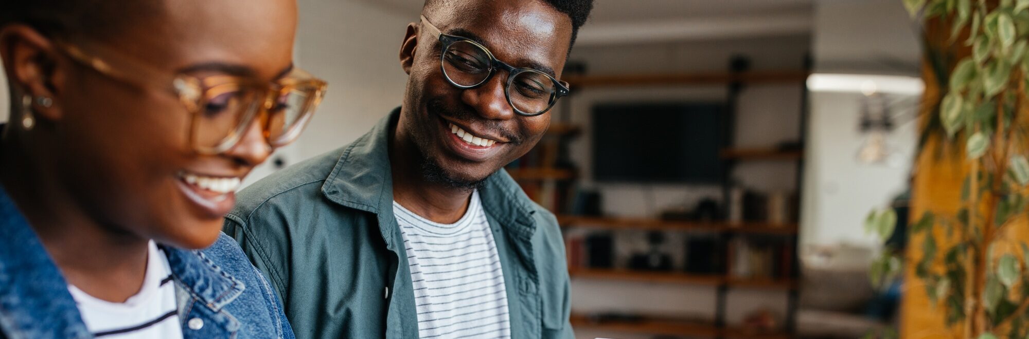 Black couple enjoying at home and using technology